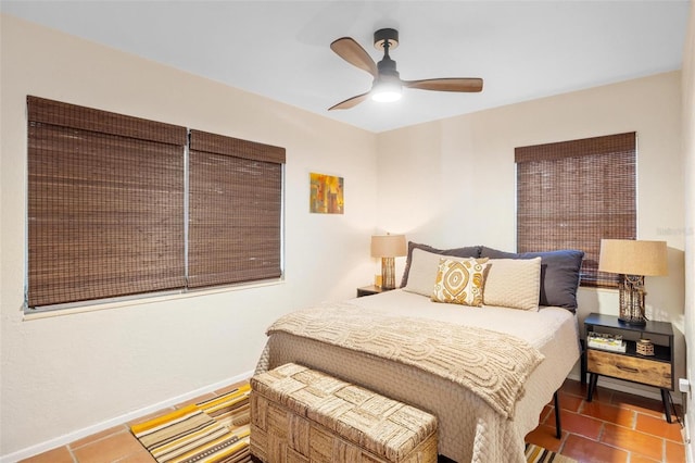 bedroom featuring tile patterned floors, baseboards, and ceiling fan