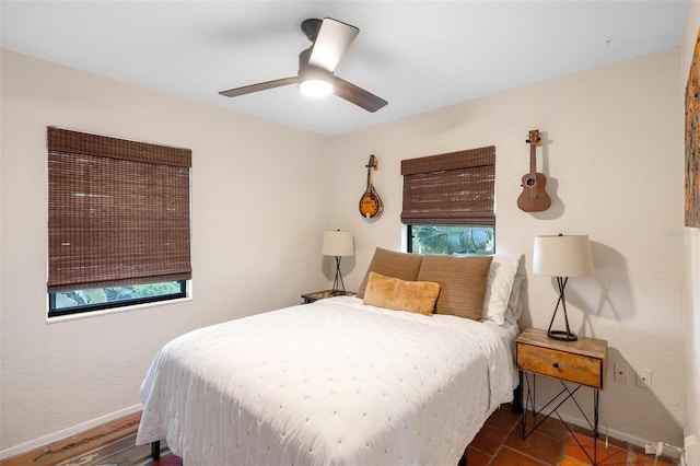 bedroom featuring baseboards and ceiling fan