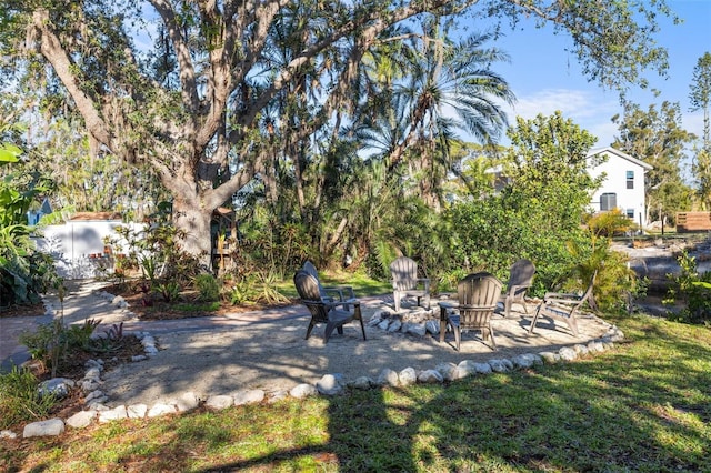 view of yard featuring a fire pit and a patio area