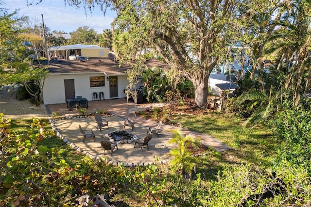 view of yard featuring a patio and an outdoor fire pit