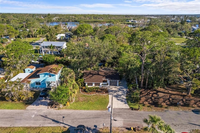 aerial view featuring a wooded view and a water view