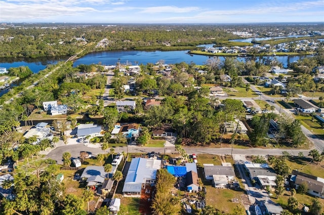 aerial view featuring a view of trees and a water view