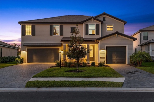 view of front facade featuring decorative driveway and a garage