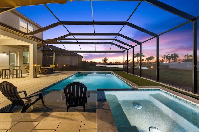 pool with a patio area, an in ground hot tub, and a lanai