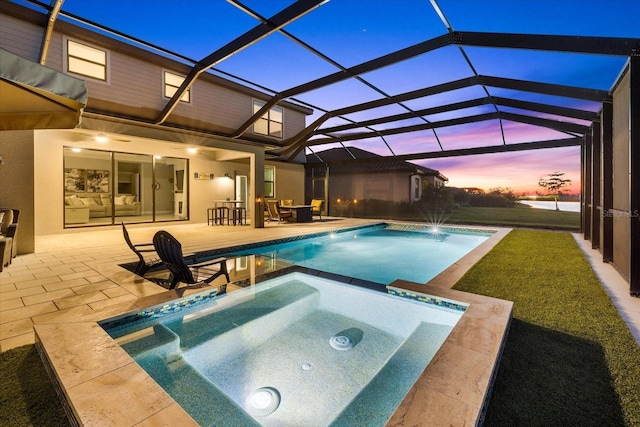 outdoor pool featuring glass enclosure, an in ground hot tub, and a patio