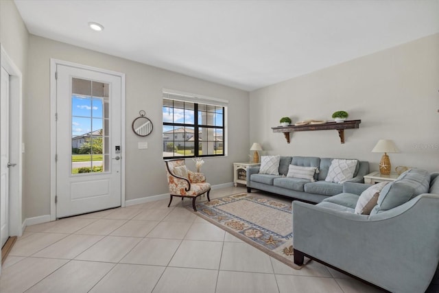 living area featuring light tile patterned floors and baseboards