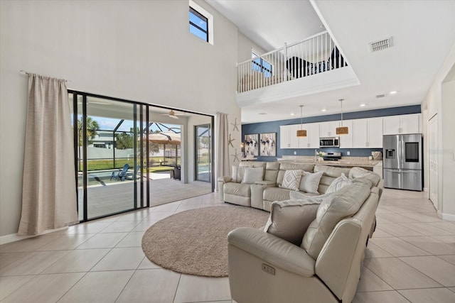 living area featuring recessed lighting, light tile patterned floors, baseboards, and visible vents