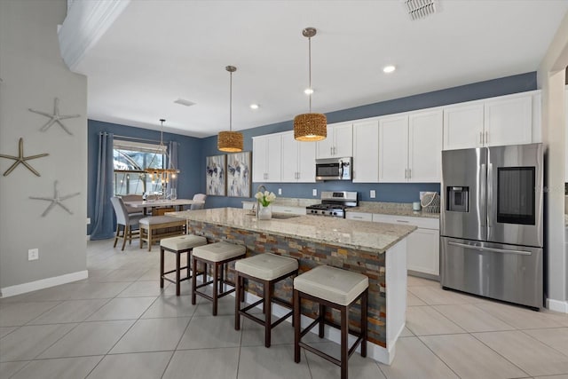 kitchen with light tile patterned floors, visible vents, white cabinets, and stainless steel appliances