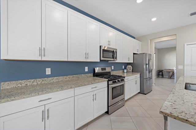 kitchen with white cabinets and appliances with stainless steel finishes