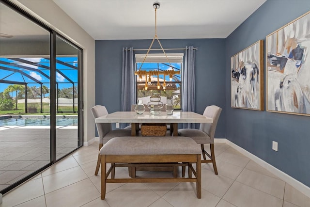 dining area with light tile patterned floors, baseboards, and a sunroom