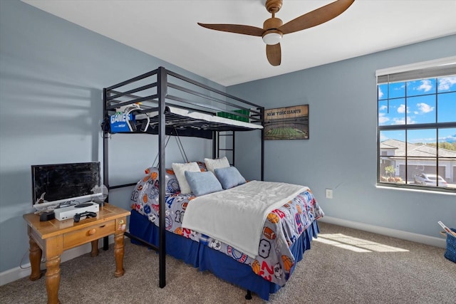 carpeted bedroom featuring a ceiling fan and baseboards