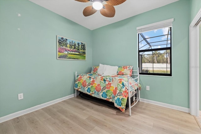 bedroom with wood finished floors, baseboards, and ceiling fan