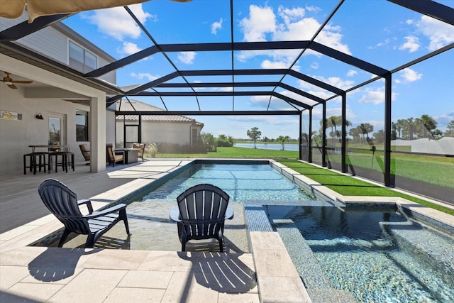 pool featuring glass enclosure, an in ground hot tub, a patio area, and a lawn