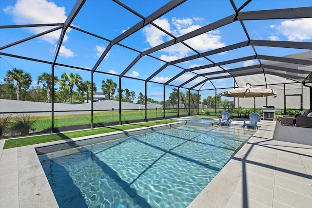 view of pool featuring area for grilling, a pool with connected hot tub, glass enclosure, a yard, and a patio area