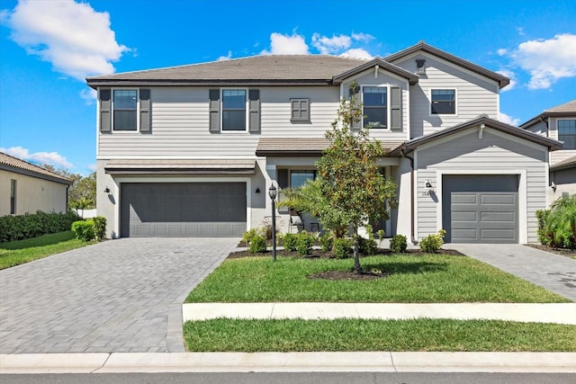 view of front facade featuring decorative driveway and an attached garage