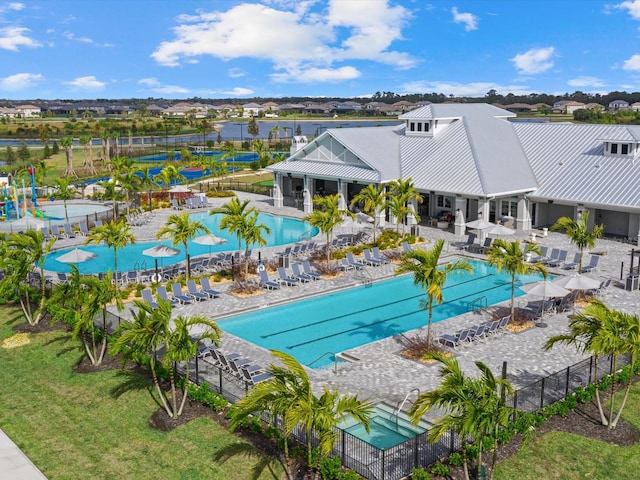 pool featuring fence, a lawn, and a patio area