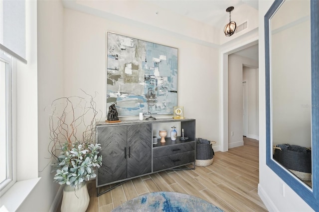 interior space with visible vents, baseboards, and wood tiled floor