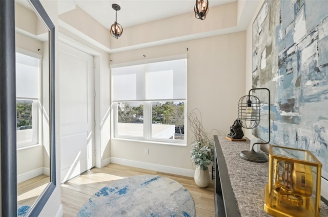 sitting room featuring baseboards and light wood-style floors