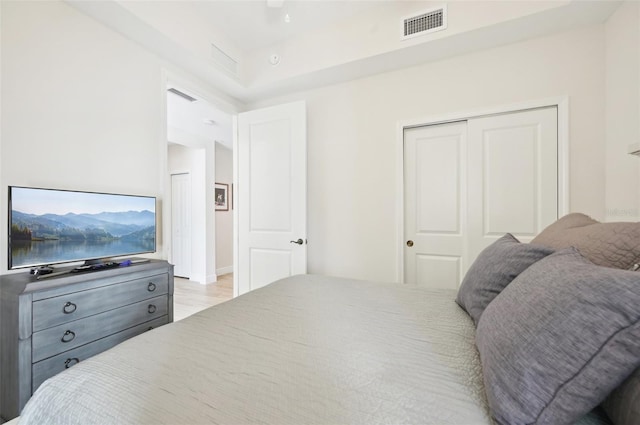 bedroom with visible vents, a closet, and light wood-type flooring