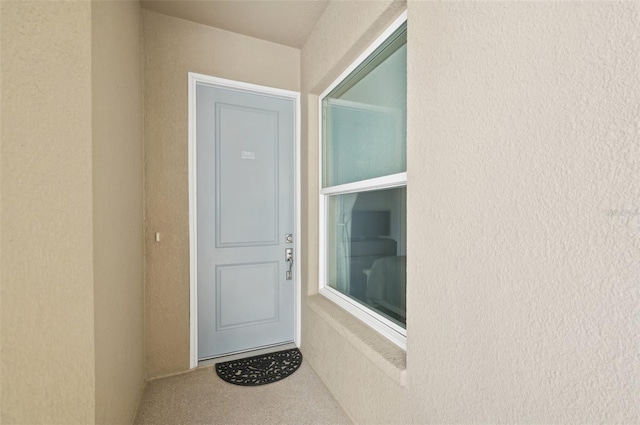 entrance to property with stucco siding