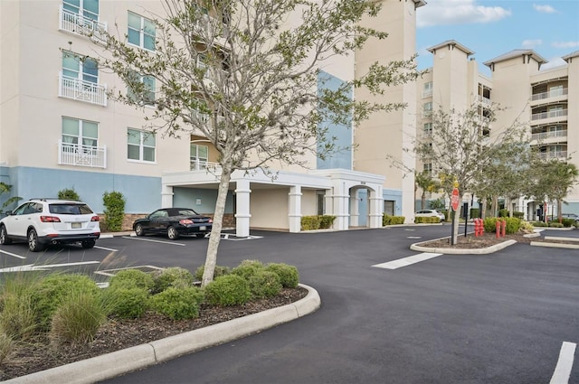 view of building exterior with uncovered parking