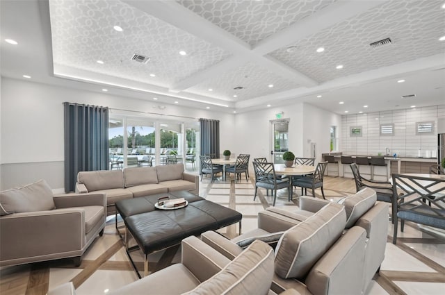 living area with recessed lighting, visible vents, beam ceiling, and coffered ceiling