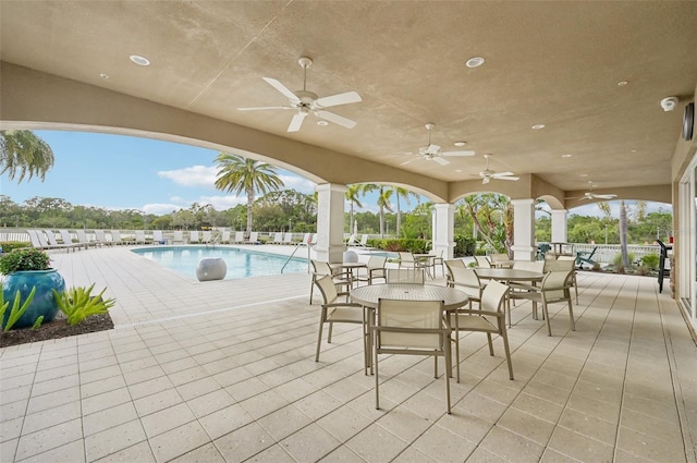 view of patio / terrace featuring a community pool and outdoor dining space