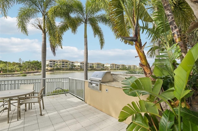 view of patio featuring a water view and area for grilling