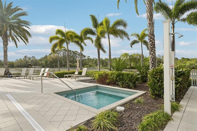 view of pool with a patio area and fence