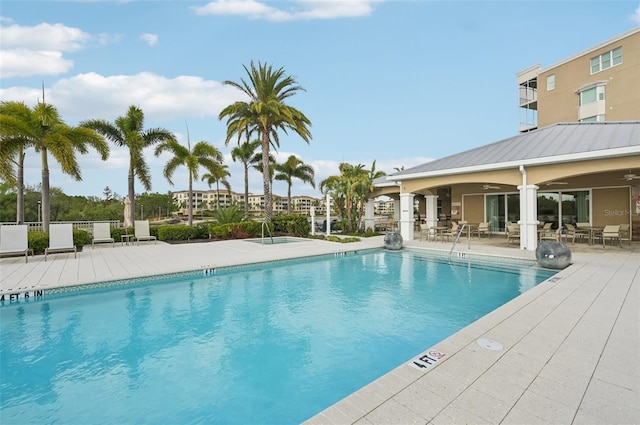 pool featuring a ceiling fan and a patio area