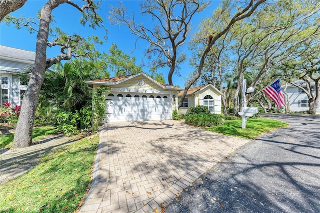 view of front of house featuring decorative driveway and a garage