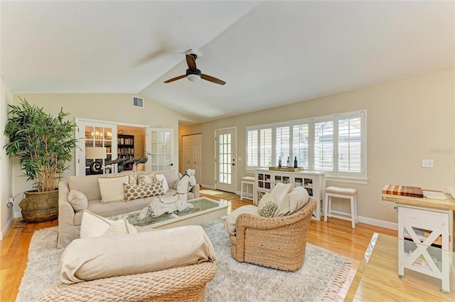 living area with a ceiling fan, baseboards, visible vents, lofted ceiling, and light wood-type flooring