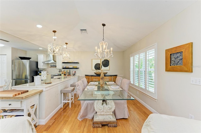 dining room featuring light wood-type flooring, visible vents, recessed lighting, baseboards, and a chandelier