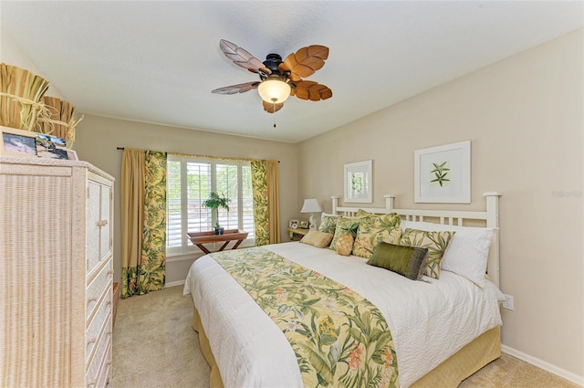 bedroom featuring light carpet, baseboards, and vaulted ceiling