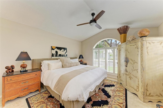 bedroom featuring light colored carpet, a ceiling fan, and lofted ceiling