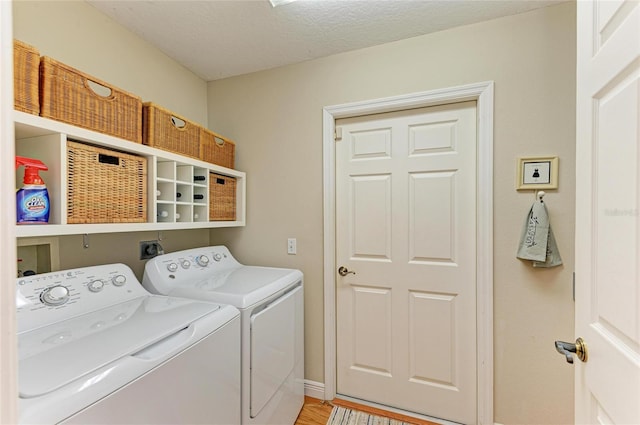 laundry area featuring laundry area, baseboards, independent washer and dryer, and a textured ceiling