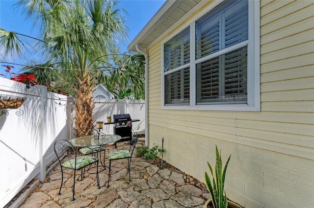 view of patio / terrace featuring a grill and fence