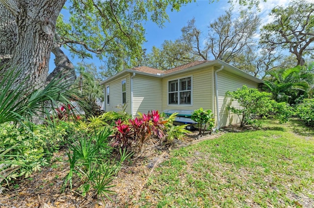 view of home's exterior with a lawn