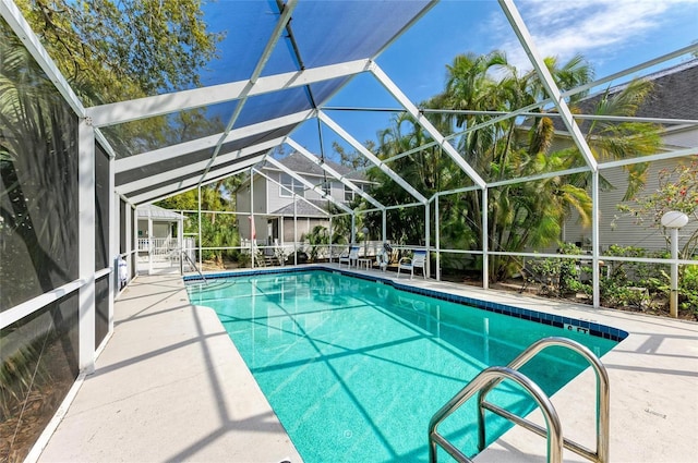 outdoor pool with a lanai and a patio area