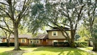 back of house with a lawn