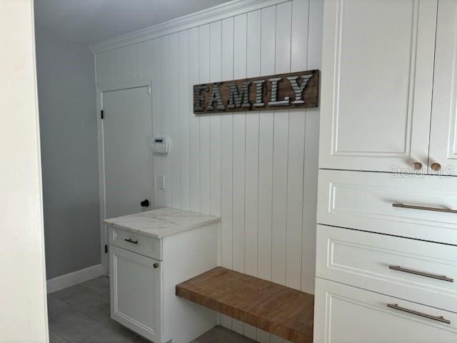 mudroom featuring baseboards and ornamental molding