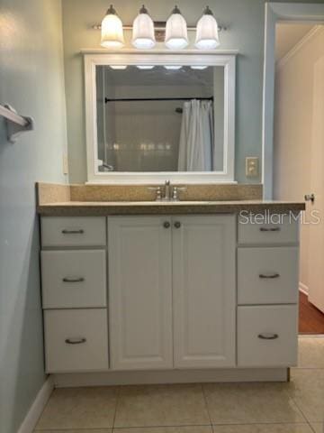 bathroom with tile patterned floors and vanity