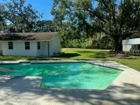 pool featuring a yard and a water slide