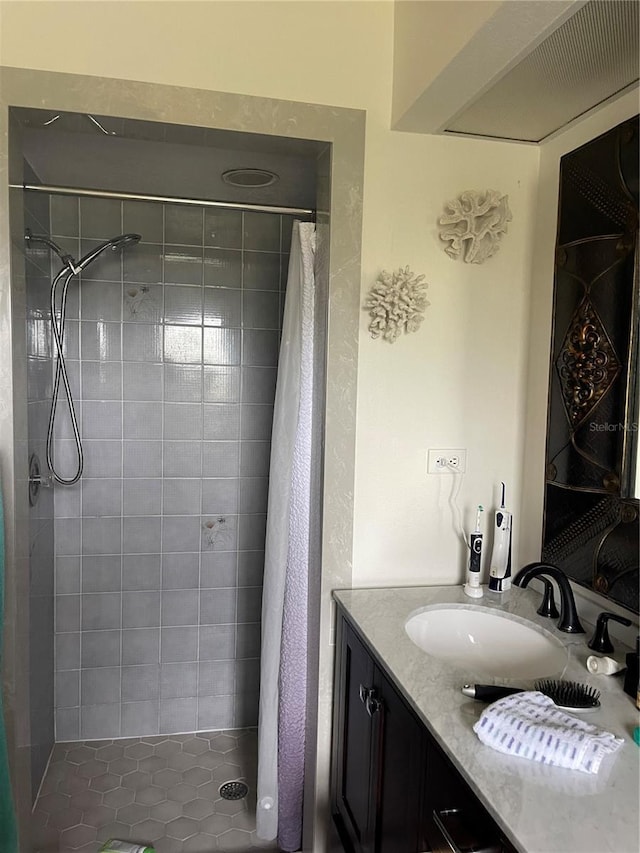 full bathroom with a stall shower and vanity