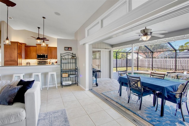 interior space featuring visible vents, glass enclosure, outdoor dining area, and fence