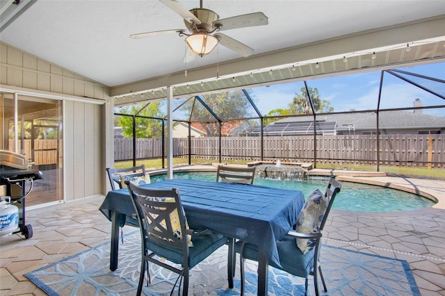 view of pool with a hot tub, ceiling fan, glass enclosure, a fenced backyard, and a patio