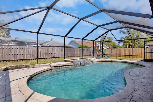 view of pool with a lanai, a fenced in pool, a fenced backyard, and a patio area