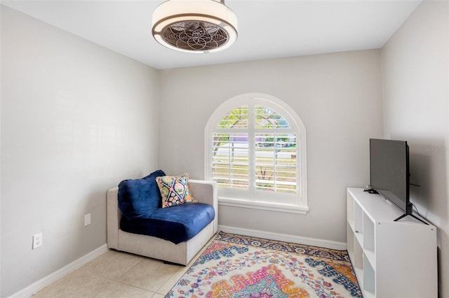 living area featuring light tile patterned floors and baseboards