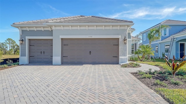 garage with decorative driveway