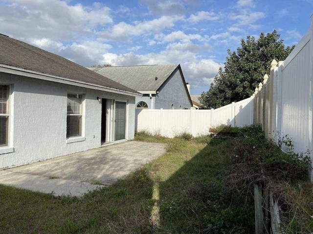 view of yard featuring a patio area and a fenced backyard